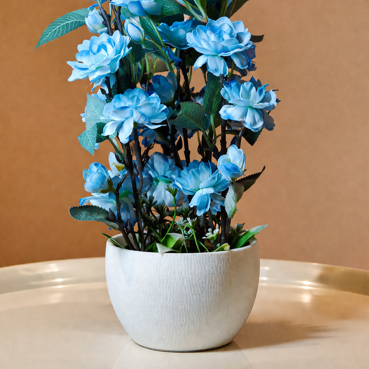 White Flower Waise Along With Plastic Leaves And Blue Flowers
