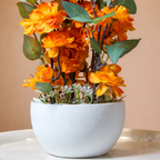 White Flower Waise Along With Plastic Leaves And Orange Flowers