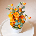 White Flower Waise Along With Plastic Leaves And Orange Flowers