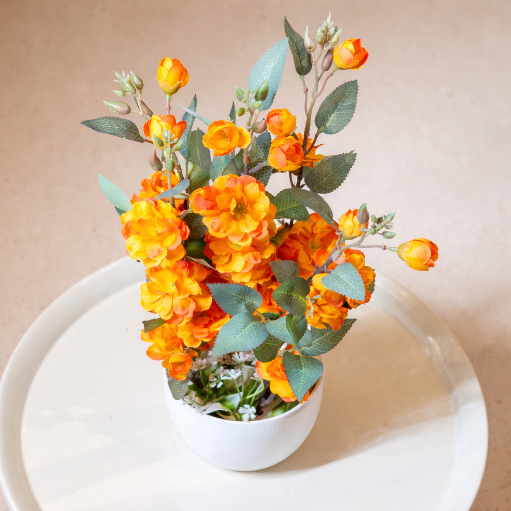 White Flower Waise Along With Plastic Leaves And Orange Flowers