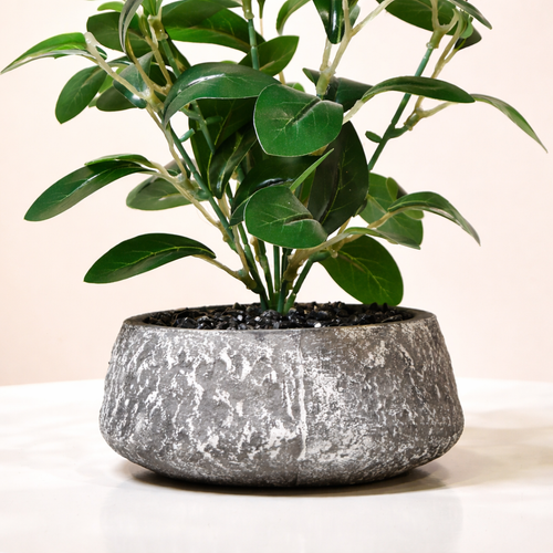 Black Flower Waise Along With Plastic Leaves.